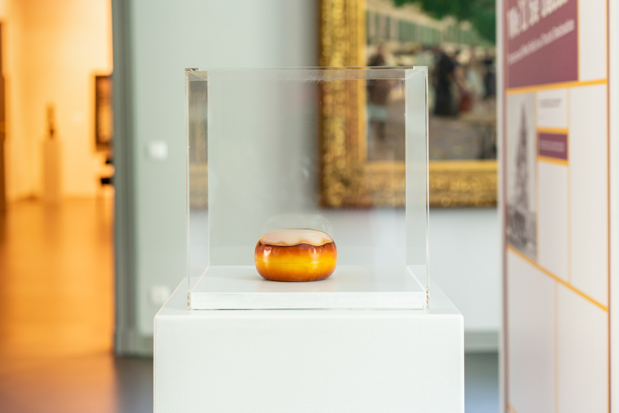 Dose in der Form eines Berliner-Pfannkuchens in einer Vitrine
